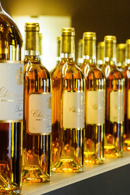 A row of wine bottles arranged neatly side by side