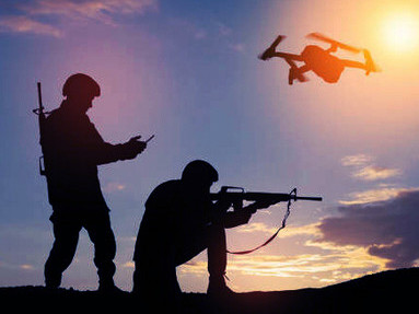 A soldier's silhouette operating a drone and laptop for battlefield reconnaissance during a military mission