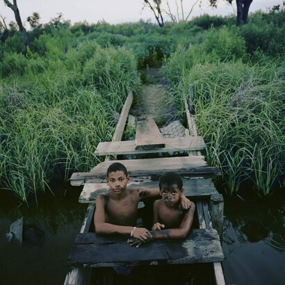 Kael Alford, Joseph and Jasmon Jackson play in the bayou, Isle de Jean Charles, LA, 2010. Courtesy of Ogden Museum of Southern Art