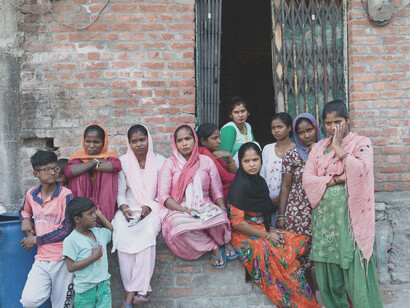 In rural Haldwani, Uttarakhand, a group stands outside a modest building, reflecting the everyday realities of poverty and social inequality