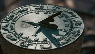 An antique sundial engraved with zodiac symbols under natural light, representing how scientific observation and pseudoscientific belief have long shared visual traditions