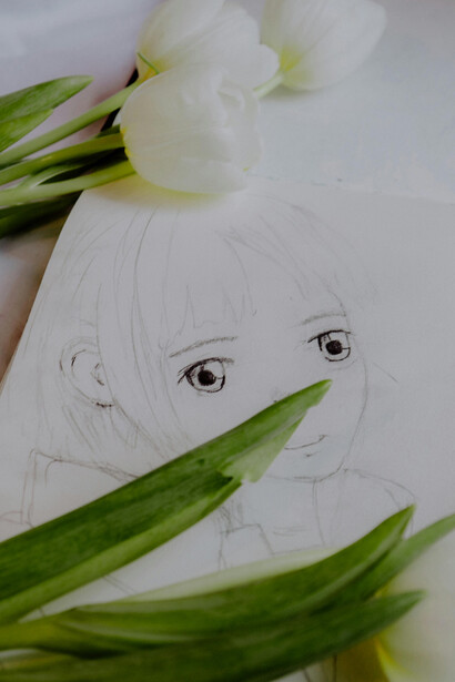 White tulips placed on an anime drawing in Paris, Île-de-France, France