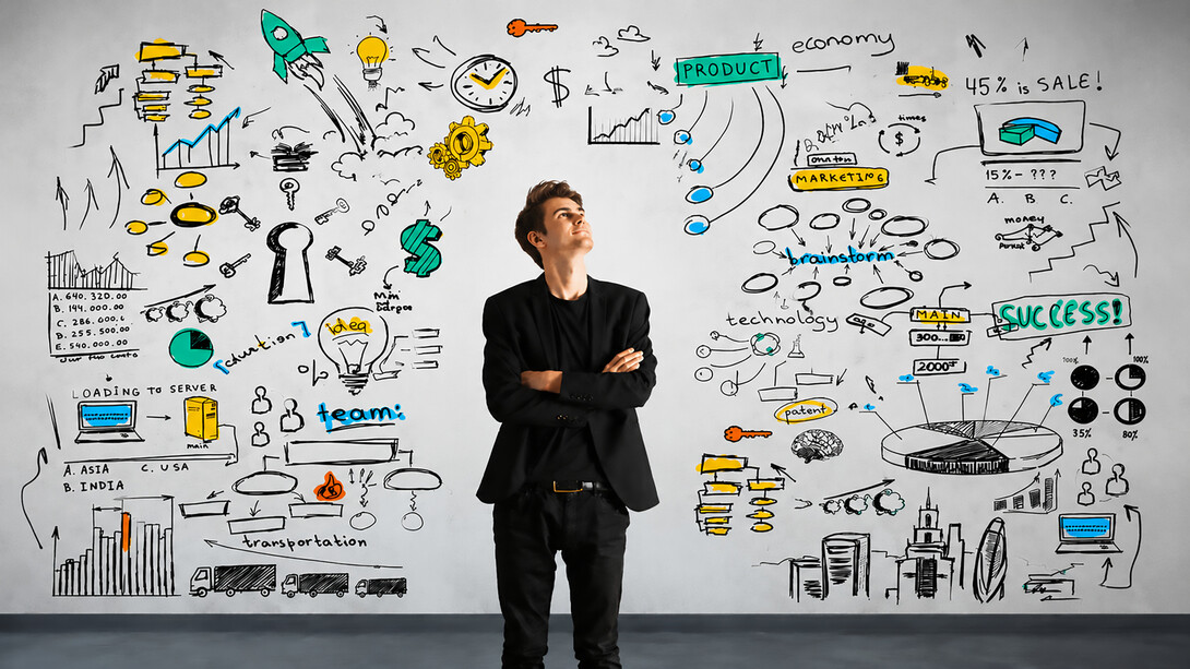 A young entrepreneur reflects on innovation, strategy, and business growth while surrounded by a visual map of ideas and opportunities
