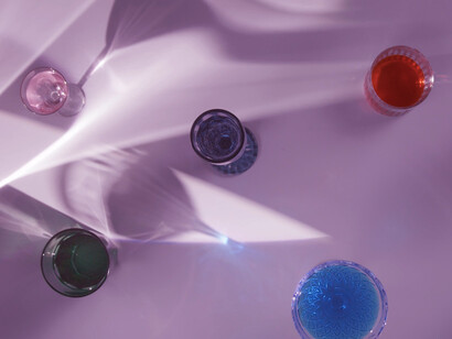Sunlight dances across the glass cups, creating intricate shadows that remind us of the layers of meaning in our everyday lives