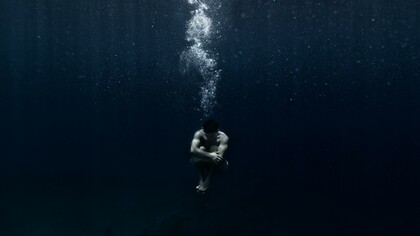 Man sitting underwater 