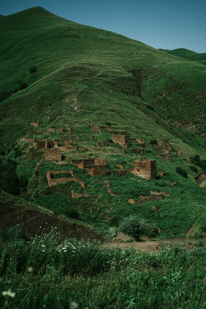 The remains of an old settlement among the lush hills of Chechnya, Russia, reflecting the history that continue to shape the region beyond its wartime past