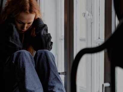 In a moment of introspection, a girl grappling with depression and anxiety gazes out the window, her thoughts a turbulent sea