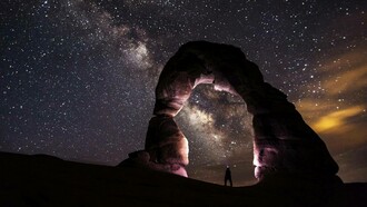 A man observes the galaxy and reflects on his own insigificance