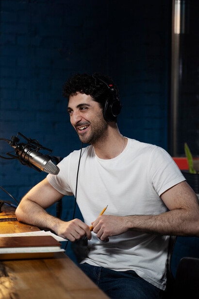A professional in a studio, wearing headphones and speaking into a microphone, handling subtitles and dubbing tasks