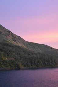 A mountain in Philippines set against the backdrop of a sunset, representing the beauty that awaits those willing to climb to the peak to catch the best views