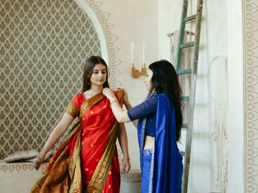 Women dressed in traditional Indian sarees, showcasing Banarasi silk