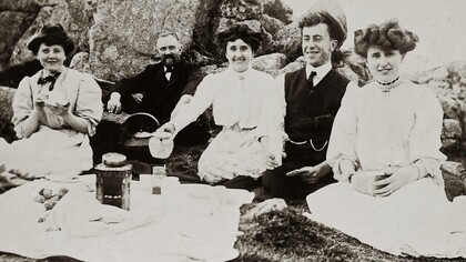 An old photo of friends at a picnic having tea