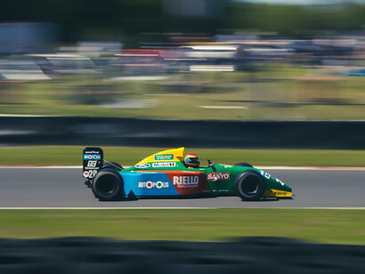 Blue and yellow f 1 car on road