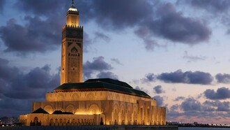 The Hassan II Mosque towering over Casablanca at sunset, showing Morocco’s balance of tradition and modern identity