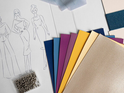 Essential elements for fashion design in the studio: fabrics and designs laid out on the table
