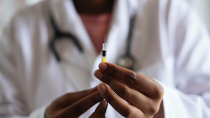 Doctor measuring a dose of vaccine