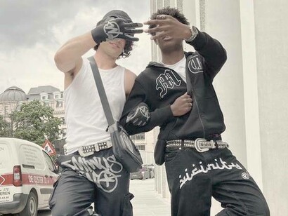 Streetwear wore by two men flashing a pair of jeans and accessories 