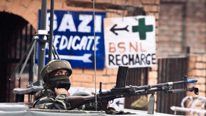 A soldier guards the roadside checkpoint outside Srinagar International Airport (SXR) in Jammu and Kashmir, India
