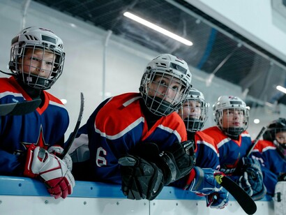 A group of young ice hockey players standing together, symbolising the beginnings of structured sport