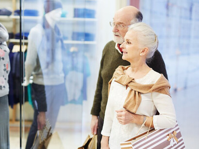 A senior couple shopping for new clothes during their retirement
