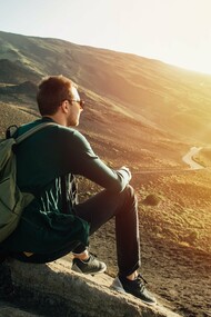 Perched atop a mountain, a solo traveler finds a moment of reflection and gains a confidence boost that only venturing beyond the comfort zone can provide