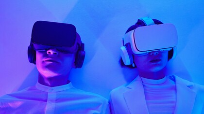 Two people wearing virtual reality headsets 