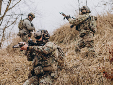 Private military contractors engaged in combat, heavily armed and operating as security forces