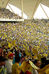The Al-Nassr fans fill the King Fahd Stadium in Saudi Arabia, creating an electric atmosphere with their passionate support