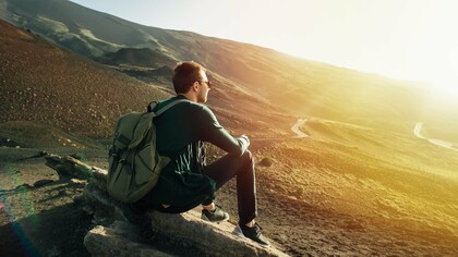 Perched atop a mountain, a solo traveler finds a moment of reflection and gains a confidence boost that only venturing beyond the comfort zone can provide