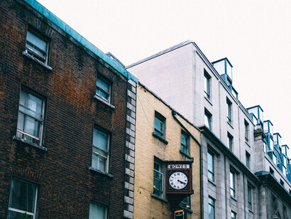Old building fronts contrasted with a cloudy sky