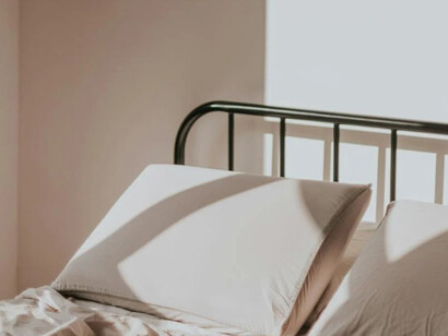 A pillow and bed, once a place of rest and now a deep reflection void of being in the now