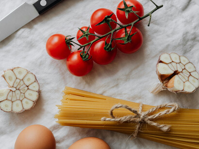 Dry pasta, eggs, garlic and cherry tomatoes on a table