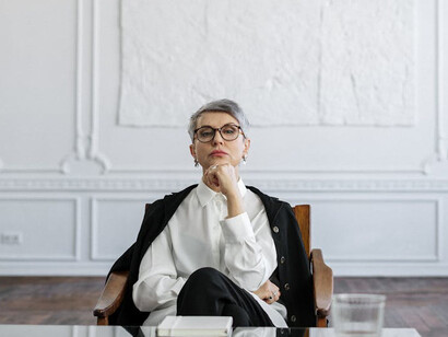 Her thoughtful expression highlights the journey of reconsidering our assumptions and the strength found in being willing to change our minds