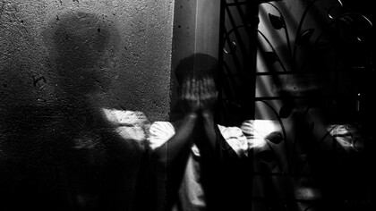A person sat with their head in their hands 