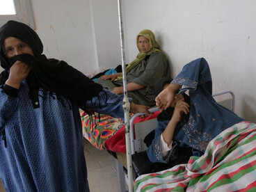 A woman, Om Ahlim, sits on a hospital bed with her daughter, Suid Rajab, who is suffering from fever and cerebrospinal inflammation, at a public hospital in Sharqia province, Egypt, 260 km northeast of Cairo, on June 10, 2008