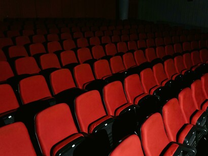 A scene from an AI-written script: a deserted movie theater with empty seats