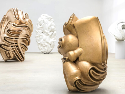 This image features works by Tony Cragg from his 2017 exhibition A Rare Category of Objects at the Yorkshire Sculpture Park. The pieces, from his Rational Beings and Contradiction series, explore twisting, organic geometries in bronze, marble, and fibreglass. From left to right: Industrial Nature (2015, bronze), Elliptical Column (2012, white fibreglass), McCormack (2015, bronze), and (Study for Rational Being) (2014, white marble). Each stands 1.5–2.5 metres tall, reflecting Cragg’s study of material density and fluid form