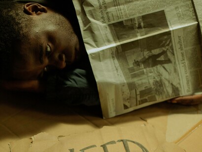 Homeless man gazes pensively