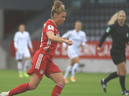 Women’s soccer players in action during a match, showcasing the spirit of female athletics