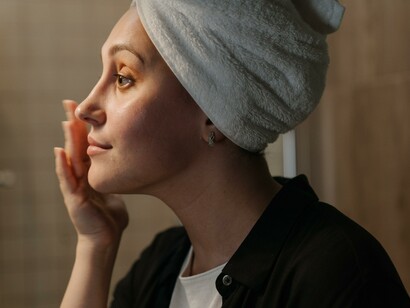 Woman applying skin care product