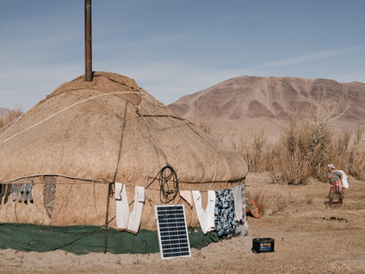 Woman going in yurt in steppe, Mongolia