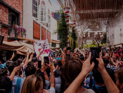In the picturesque district of Miraflores, Peru, an eager crowd assembles in front of a building, filled with anticipation for the 2022 FIFA World Cup