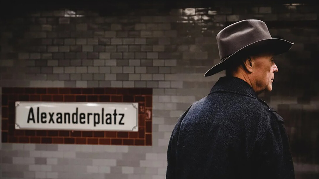 Man wearing a cowboy hat and black coat, seen from behind, Berlin, Germany