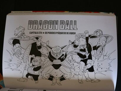 A Dragon Ball manga page displayed across an open book, reflecting the international reach of manga as a cultural export