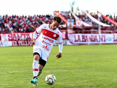 A focused player in action, showing the dedication and intensity that defines every moment on the pitch