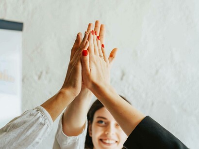 Several people put their hands together to show solidarity for the project