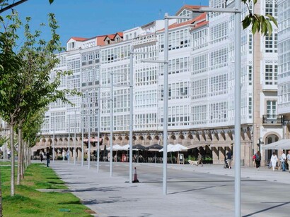 A pedestrian walkway with nearby cafés in Avenida de la Marina in A Coruña, Spain
