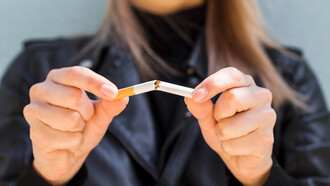 A woman breaking free from the shackles of a harmful smoking habit, embracing a healthier lifestyle and newfound freedom