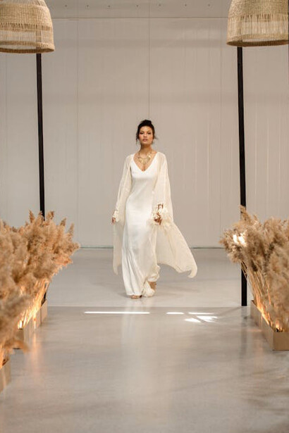 A model in a flowing white dress embodies the fashion industry's ability to navigate economic uncertainties and climate challenges