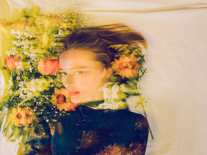 A moment of withdrawal, where beauty masks turmoil and floral softness